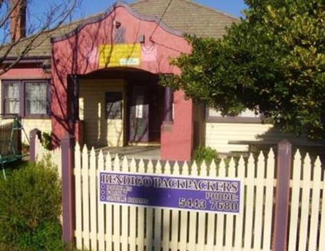 Picture of a pink and purple building, the old Bendigo Backpackers Hostel