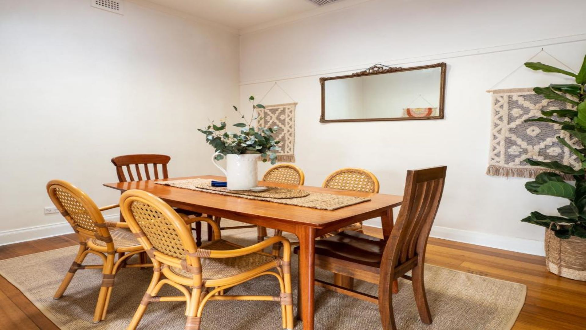 Image is of a dining room with a wooden table and chairs